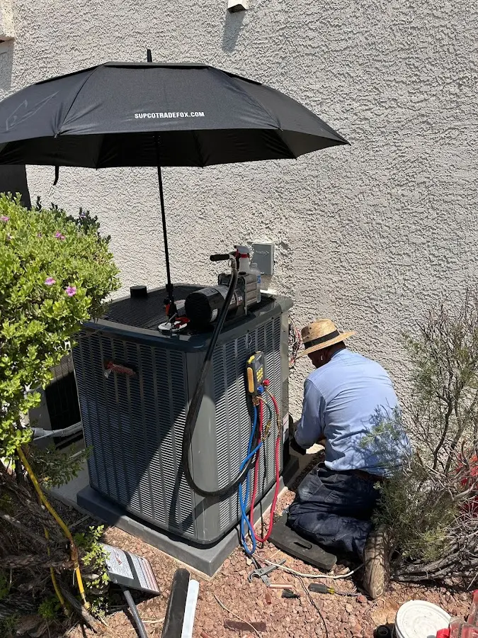 HVAC technician performing outdoor AC maintenance in Morgan City